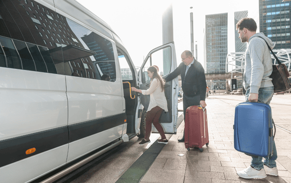A group of travelers hop aboard a sleek minibus
